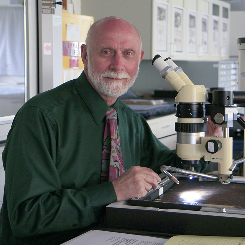 Joseph G. Barabe with microscope, research Microscopist in art and manuscript materials analysis, The Lazarus Project